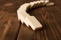 Playing dominoes on a wooden table. Domino effect Royalty Free Stock Photo