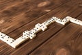 Playing dominoes on a wooden table. Domino effect Royalty Free Stock Photo