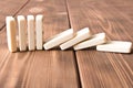 Playing dominoes on a wooden table. Domino effect Royalty Free Stock Photo