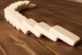 Playing dominoes on a wooden table. Domino effect Royalty Free Stock Photo