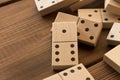 Playing dominoes on a wooden table. Leisure games concept. Domino effect Royalty Free Stock Photo