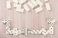 Playing dominoes on a wooden table Royalty Free Stock Photo