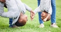 Playing is the doorway into the children hearts. two children hanging upside down by their parents outside. Royalty Free Stock Photo