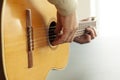 Playing fingerpicking on an old acoustic spanish guitar in close up with selective focus Royalty Free Stock Photo
