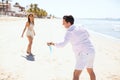 Playing with a flying disc at the beach Royalty Free Stock Photo