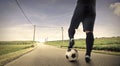 Playing football on a long way Royalty Free Stock Photo