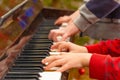 Playing the four hands piano, side view