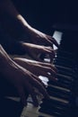 Playing four male hands on the piano. palms lie on the keys and play the keyboard instrument in a music school. student learns to