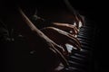 Playing four male hands on the piano. palms lie on the keys and play the keyboard instrument in a music school. student learns to Royalty Free Stock Photo