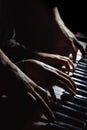 Playing four male hands on the piano. palms lie on the keys and play the keyboard instrument in a music school. student learns to Royalty Free Stock Photo