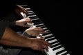 Playing four male hands on the piano. palms lie on the keys and play the keyboard instrument in a music school. student learns to