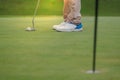 Playing golf preparing shot man putting on green Royalty Free Stock Photo