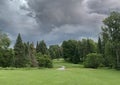 A green golf course and blue stormy sky on a beautiful summer day in Canada Royalty Free Stock Photo