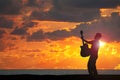 Playing guitar on the beach at sunset Royalty Free Stock Photo