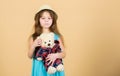 Playing with her plush friend. Adorable girl child with cute stuffed animal doll. Small child cuddling teddy bear toy Royalty Free Stock Photo