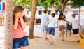 Playing hide and seek. Girl covering eyes her hands