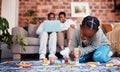 Playing, house and a child with building blocks and parents on the sofa with a laptop and relax. Happy, black family and Royalty Free Stock Photo