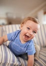 Playing, laughing or portrait of baby in sofa or home for fun, growth or learning alone in living room. Happy, boy or Royalty Free Stock Photo