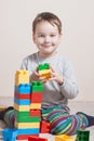 Playing little boy with colored cubes