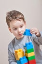 Playing little boy with colored cubes