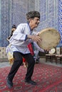 Playing local musical instrument known as tambourine, Khiva, Uzbekistan