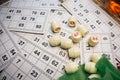 Playing lotto game. Cubes with figure on bingo card background. Nostalgia lifestyle. Table games. Retro games