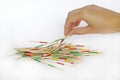 Playing mikado game pick-up sticks Royalty Free Stock Photo