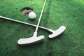 Playing mini golf on artificial green grass outdoors. Setting goals and winning concept for family or couple. Fun vacation Royalty Free Stock Photo