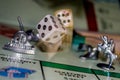 playing Monopoly game board with dice in motion Royalty Free Stock Photo