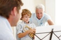 Playing, music and grandpa and child with trumpet for practice, lesson and skills for talent show. Family, creative Royalty Free Stock Photo