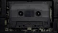 Playing old audio tape cassette tape close-up. Popular audio technology from 1980s and 1990s.