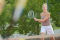 She playing outdoor tennis