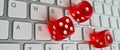 Playing red dice on computer keyboard closeup Royalty Free Stock Photo