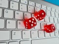 Playing red dice on computer keyboard closeup Royalty Free Stock Photo