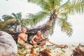 Playing in Robinzones: father and son built a hut from palm tree Royalty Free Stock Photo