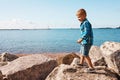 Playing on the rocky side. an adorable little boy playing on the rocks. Royalty Free Stock Photo