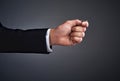 Playing it safe doesnt always lead to success. Cropped studio shot of a businessmans hand flipping a coin against a gray Royalty Free Stock Photo