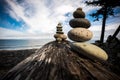 Playing with stacking rocks on a log at Agate Beach, Haida Gwaii, British Columbia, Canada Royalty Free Stock Photo