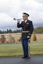 Playing taps at veterans funeral.