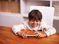 Playing with tech toys. a little boy playing with a mobile phone at home. Royalty Free Stock Photo