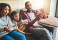 Playing their favourite family video game. an adorable little girl and her parents playing video games together on the Royalty Free Stock Photo