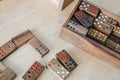 Playing traditional wooden domino game on wooden table background.Family board game, Game night vintage dominos in a row on old ru Royalty Free Stock Photo