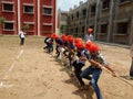 Playing tug of war with indian traditional cloths and spects.