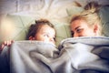 Playing under blanket with mommy. Little girl. Royalty Free Stock Photo