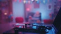 Playing a vinyl record on a vintage turntable close-up against a blurred background of a room decorated for a party. The Royalty Free Stock Photo