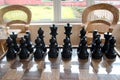 Playing wooden chess pieces. Chess photographed on a chessboard Royalty Free Stock Photo