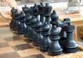 Playing wooden chess pieces. Chess photographed on a chessboard Royalty Free Stock Photo