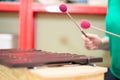 Playing a xylophone musical instrument. Shallow depth of field. Focus on the farthest musical stick