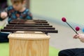 Playing a xylophone musical instrument. Shallow depth of field
