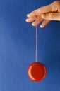 Playing yoyo over blue background